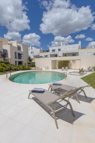 a patio with a picnic table and a pool at Casas do Forte Remos 5pax by Portugal hideaway in Cabanas de Tavira