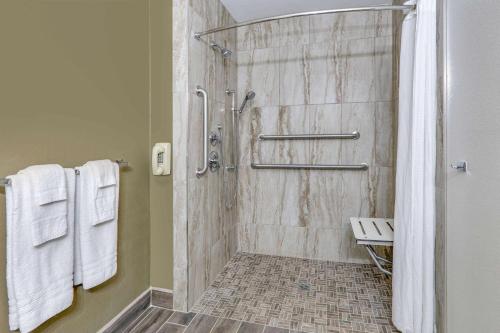 a bathroom with a shower with a glass door at Super 8 by Wyndham Roswell in Roswell