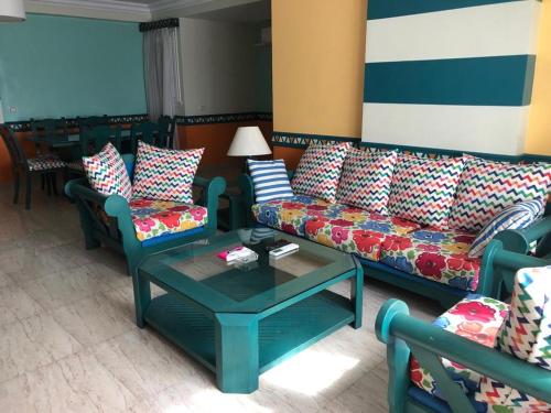 a living room with couches and a coffee table at ALMADIAFAH- No forigner المضيفة للوحدات الفندقيه -عرب فقط in Mansoura