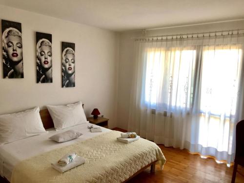 a bedroom with a bed with two faces on the wall at Apartment Adri in Rovinj