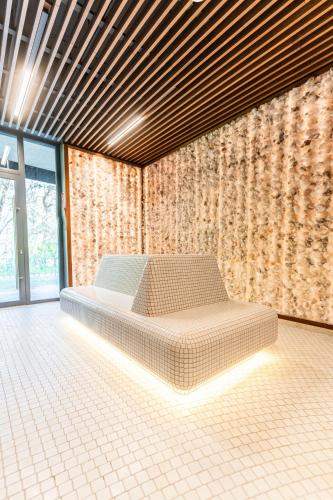 a room with a bed in the middle of it at Instytut Zdrowia Sofra FIT & SPA in Mielno