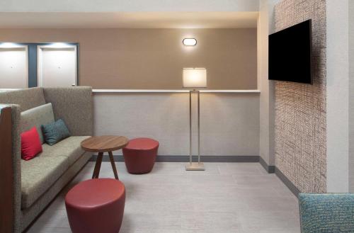 a waiting room with a couch and a table at Hampton Inn Athens in Athens