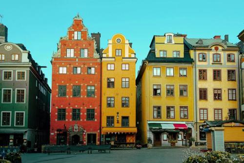 a group of colorful buildings in a city at Historisk takvåning i gamla stan in Stockholm