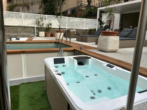 a bath tub sitting on top of a deck at DOMUS FIESCHI Rooms self check in in Genova