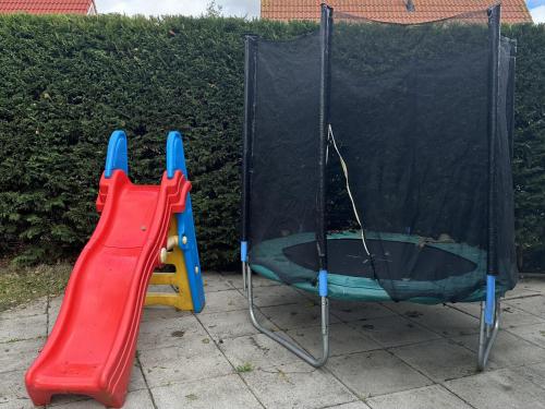 a playground with a slide and a playset at Kustverhuur, Park Schoneveld, Stern 204 in Breskens