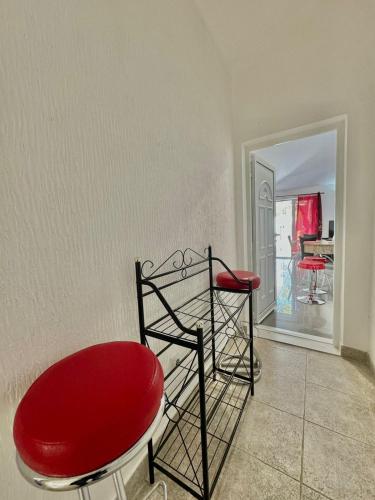 a red chair and a red stool in a room at Sun Rose Apartments Sveti Stefan in Sveti Stefan