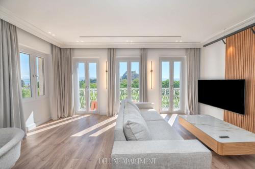 a living room with a couch and a flat screen tv at Kantoni Unique Suites in Corfu