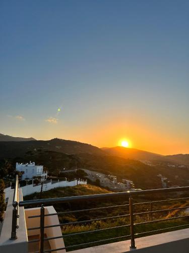 a view of the sunset from a building with a bench at Creta Vivere Villas in Agia Pelagia