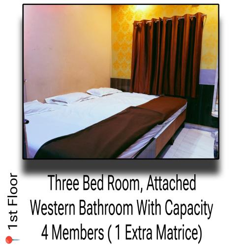 a bed in a room with a three bed roomaffiliated western bathroom with at Palange Bhakt Niwas in Tuljapur