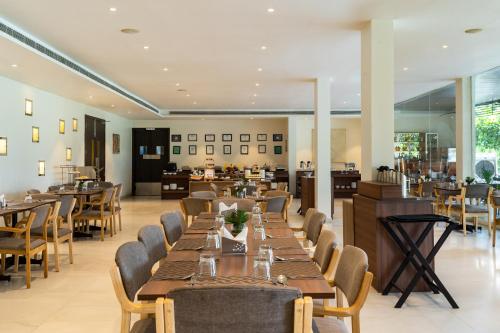 a dining room with long tables and chairs at TatSaraasa Resort & Spa, Udaipur in Udaipur