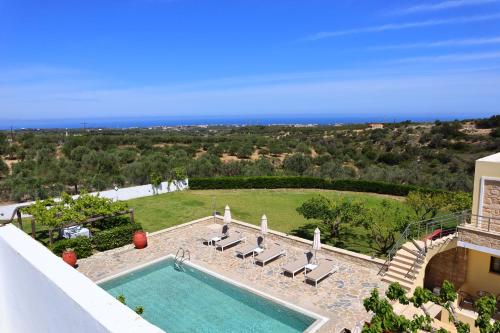 una piscina con tumbonas y el océano en Villa Stefania Dream en Érfoi