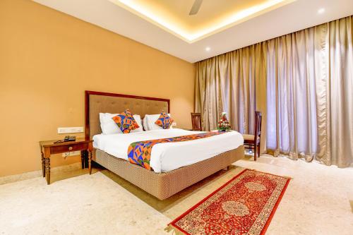 a large bedroom with a large bed and a window at FabHotel Prime The King's Court - Nr Calangute Beach in Calangute