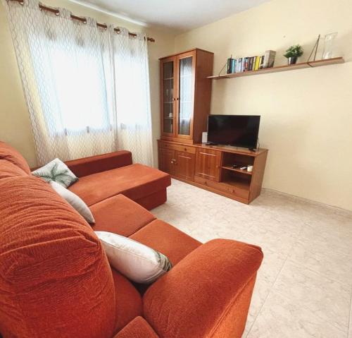 a living room with a couch and a television at CASA LORENZO in the center in Playa Blanca
