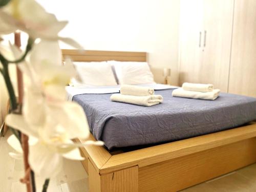 a bedroom with a bed with two towels on it at Kyklades Resort & Spa in Paralimni