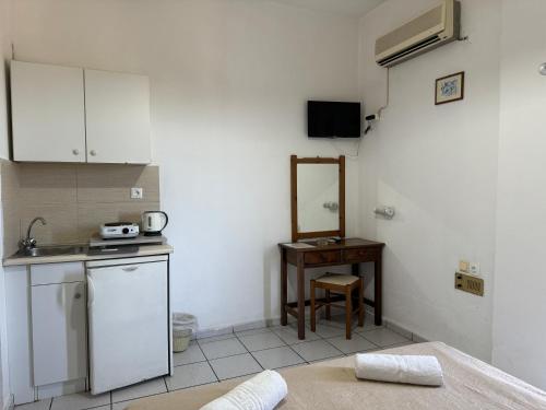 a small kitchen with a sink and a table at Zac & Georgio Studios in Amoudara Herakliou