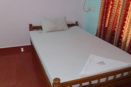 a bed in a room with a white mattress at Independent 3 Bedroom House Kottayam in Kottayam