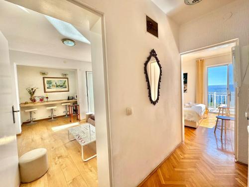 a living room with a mirror on the wall at Sun Rose Apartments Sveti Stefan in Sveti Stefan
