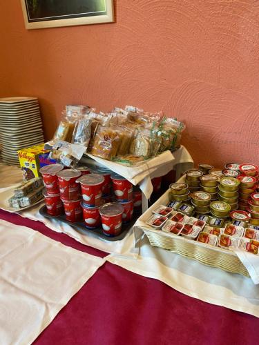 a table topped with jars of jam and other food at Hotel Rural Carlos I in Garganta la Olla