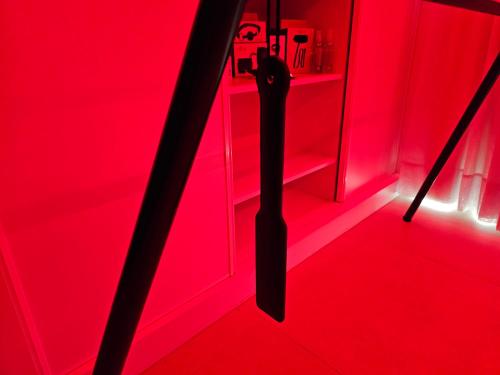 a red room with a black umbrella in a red room at MAR BIANCO - Gay Men Only in Maspalomas