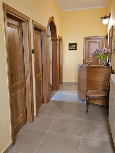 a hallway with wooden doors and a bench in a room at Guesthouse Villa Marija in Motovun
