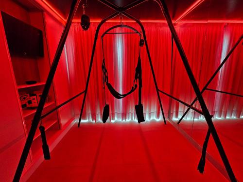 a red room with a red curtain and a red light at MAR BIANCO - Gay Men Only in Maspalomas