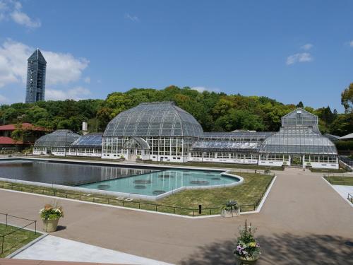 a greenhouse with a swimming pool in front of it at Vessel Hotel Campana Nagoya in Nagoya