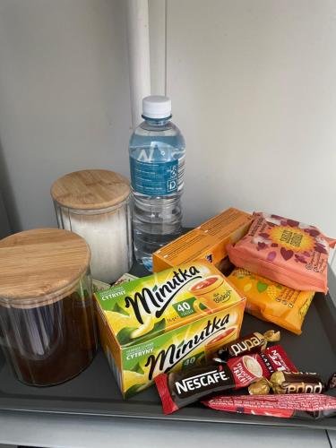 a refrigerator shelf with snacks and a bottle of water at Nemuno apartamentai in Panevėžys