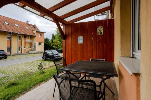 a table and two chairs on a porch at Six Corners Sunny Corner Apartment with Terrace in Pécs