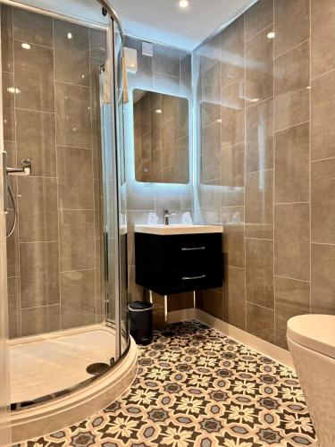 a bathroom with a sink and a shower at Marina Court in Weymouth