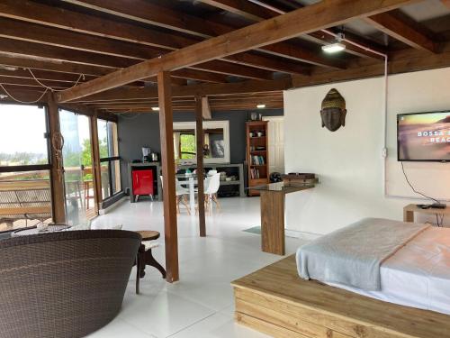 a bedroom with a bed and a tv in a room at Residencial Vale do Sol in Garopaba