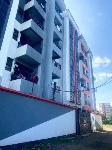 an apartment building with balconies on the side of it at Thika Furnished Apartments in Thika