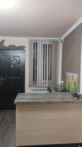 a kitchen with a sink and a black door at Dava in Gyumri