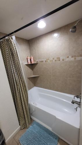 a white bath tub in a bathroom with a shower at Unit 1 - Modern Roosevelt Row Condo 2BR 1BA Downtown Stay in Phoenix
