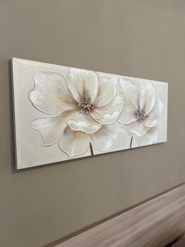a painting of white flowers on a wall at Il Buon Risveglio B&B in Agropoli
