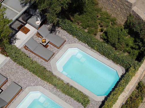 an overhead view of two swimming pools in a yard at Rodostamo Hotel & Spa- Adults Friendly in Kommeno