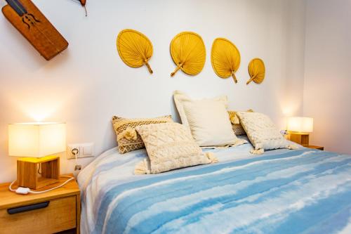 a bedroom with a bed and two mirrors on the wall at Marina Real Apartment Denia ELI in Denia