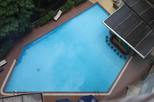 an overhead view of a large blue swimming pool at GemSuites Riverside in Nairobi