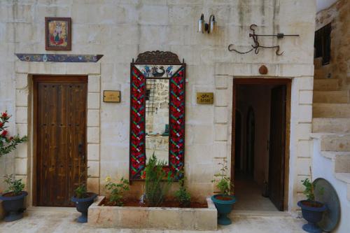 a wall with a stained glass window and two doors at Şems inn hotel in Mardin