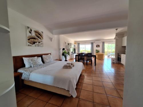 a bedroom with a bed and a dining room at Amazing Studio with Ocean View, Pool and Beach in Lagos