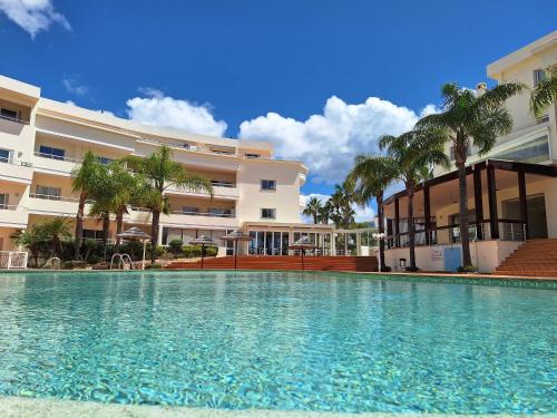 a swimming pool in front of a building at Amazing Studio with Ocean View, Pool and Beach in Lagos