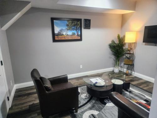 a living room with a couch and a table at Cozy Basement Suite - private entrance - Free Netflix in Edmonton