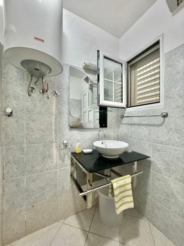 a bathroom with a sink and a mirror at Sun Rose Apartments Sveti Stefan in Sveti Stefan
