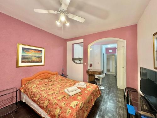 a bedroom with a bed and a ceiling fan at Sun Rose Apartments Sveti Stefan in Sveti Stefan