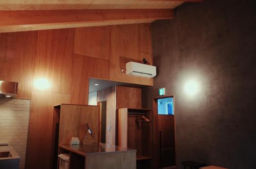 a room with a kitchen with wooden walls and a sink at MAGATAMA,INN - Vacation STAY 85473v in Sumoto