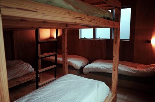a bunk bed room with three bunk beds at MAGATAMA,INN - Vacation STAY 85473v in Sumoto