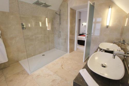 a bathroom with a shower and a sink at Cae Court Hotel in Bridgend