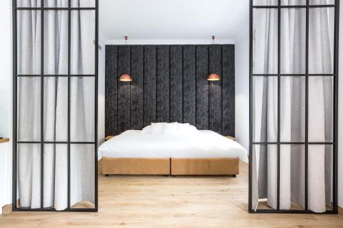 - une chambre avec un lit et un grand miroir dans l'établissement Europejski Boutique Hotel, à Radom