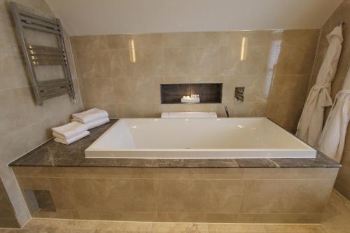 a bathroom with a large tub in a room at Cae Court Hotel in Bridgend
