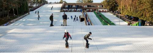 a group of people skateboarding on a ramp at a skate park at Holiday Home Hot Tub & Sauna in Bournemouth