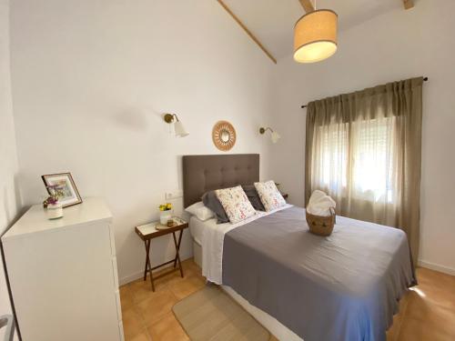 a small bedroom with a bed and a window at Tonos del Azahar in Murcia